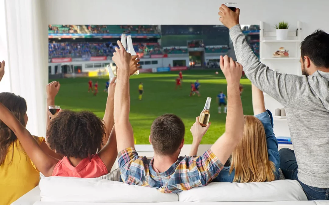 Family watching a live football match on television